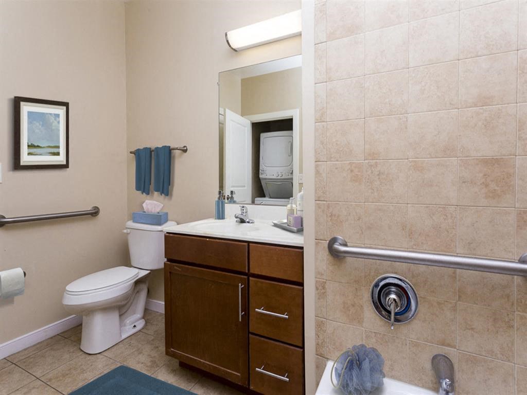 a bathroom with a sink toilet and a mirror