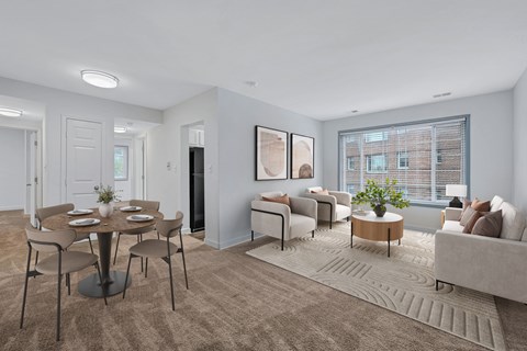 A living room with a dining table and chairs.