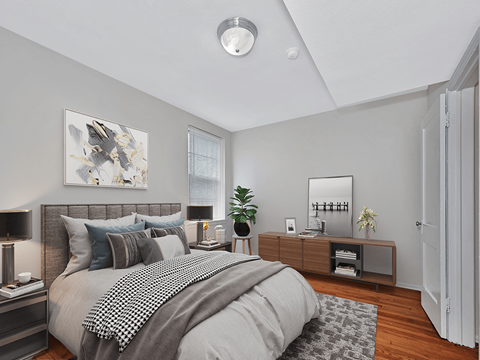 A bedroom with a large bed and a mirror on the wall.