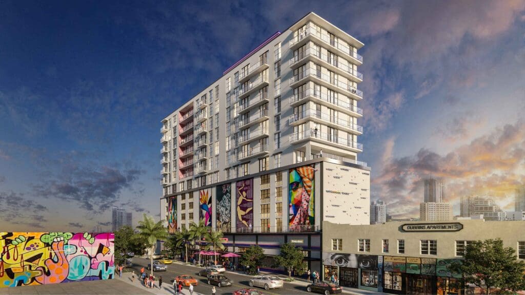A modern building with a mural on the side is depicted in the image.