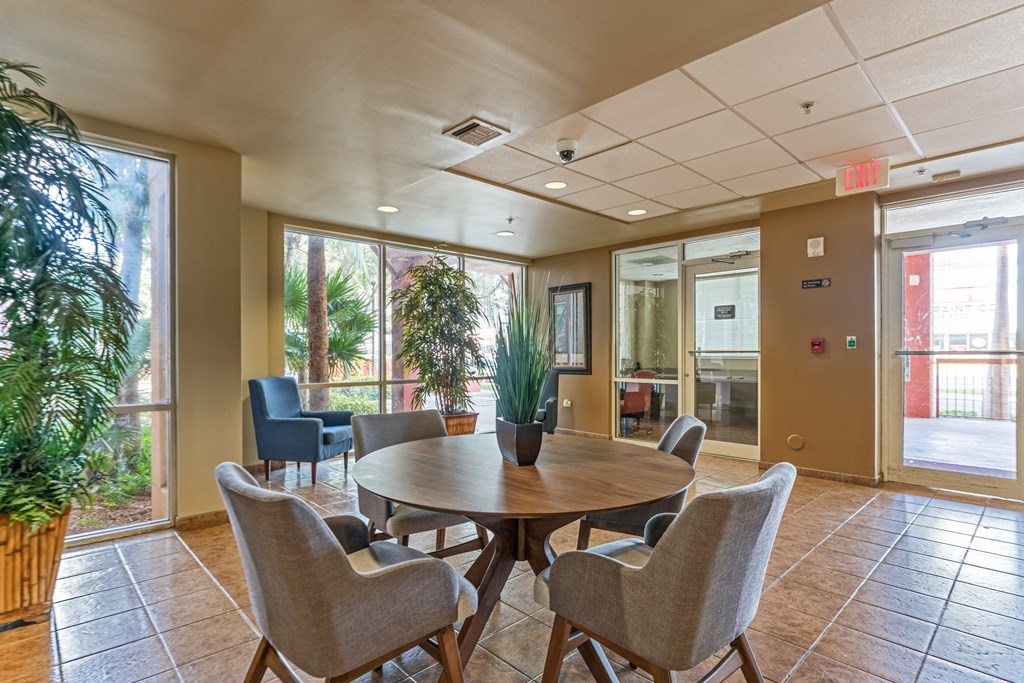 a dining area with a table and chairs in a lobby