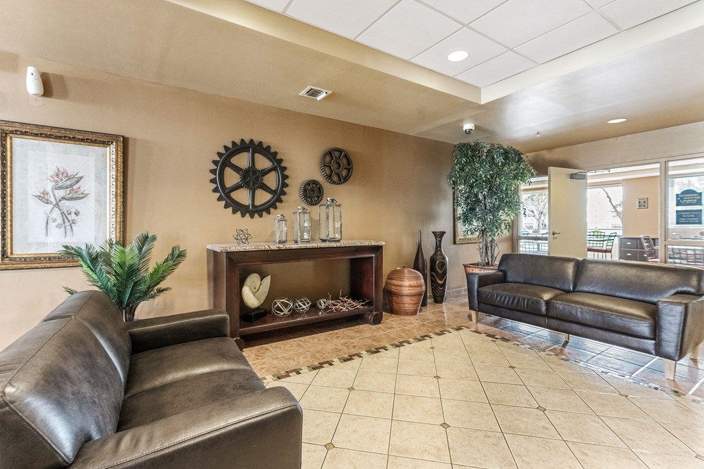 a living room with leather couches and a fire place
