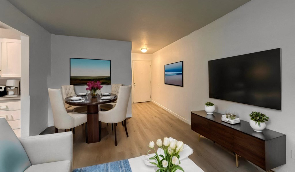 a living room and dining room with a tv and a table