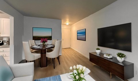 a living room and dining room with a tv and a table