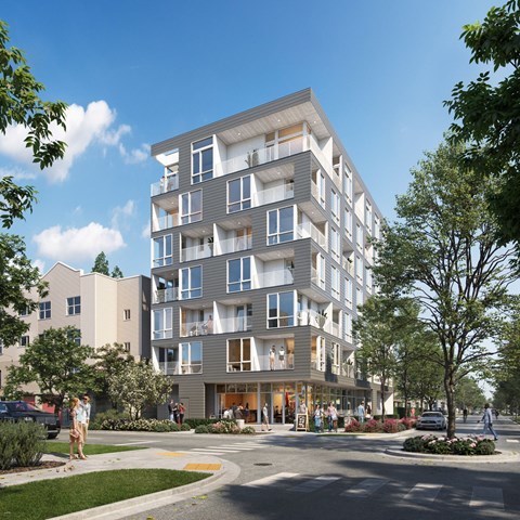 A modern apartment building with a sleek design and lush landscaping.