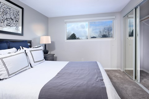 a bedroom with a large bed and a large window