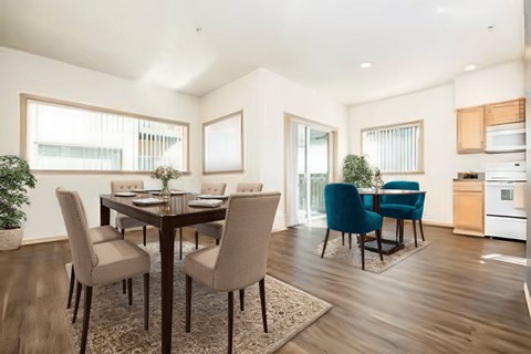 A dining room with a table and chairs.
