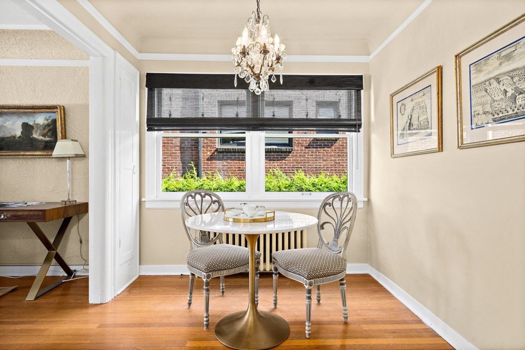 a dining room with a table and chairs and a window