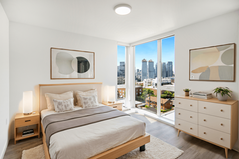 a bedroom with a bed and a large window