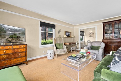 a living room with a couch and chairs and a television