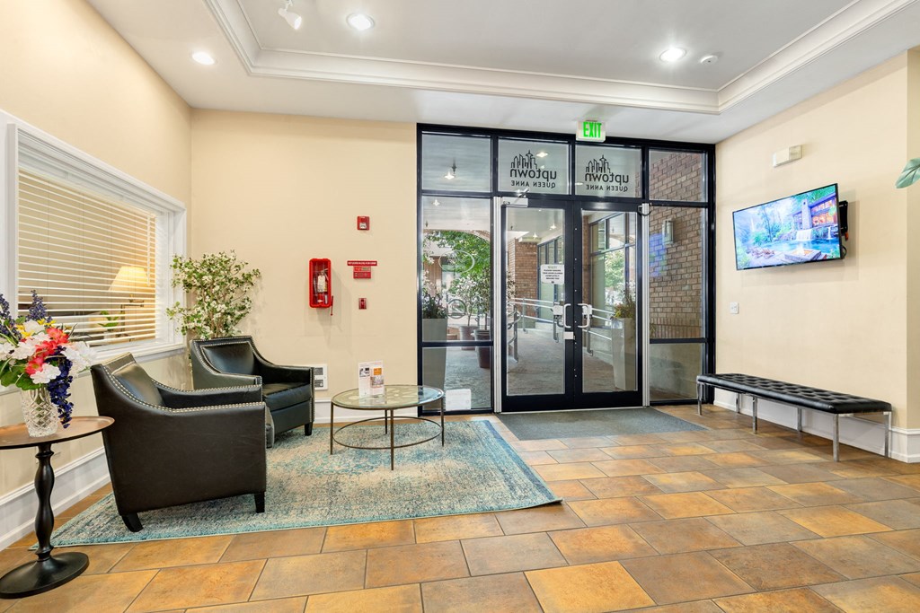a lobby with a door and a television on the wall