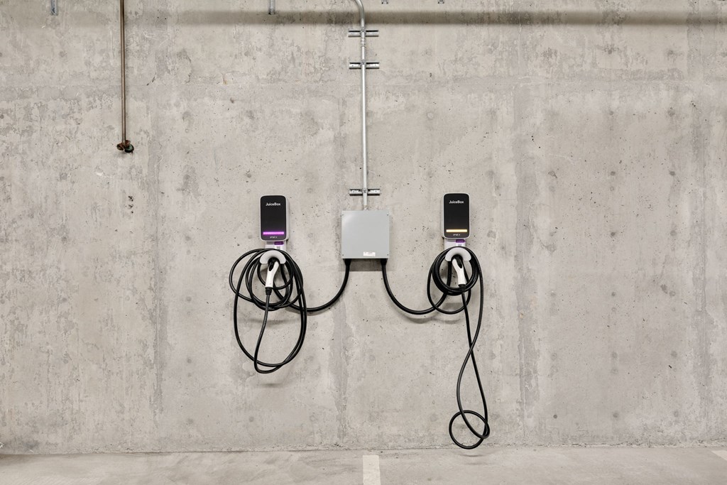 two cell phones hanging on a wall with wires