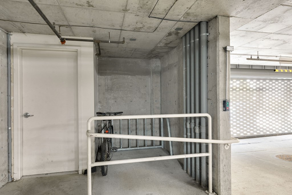 a hallway with a white railing in front of a door