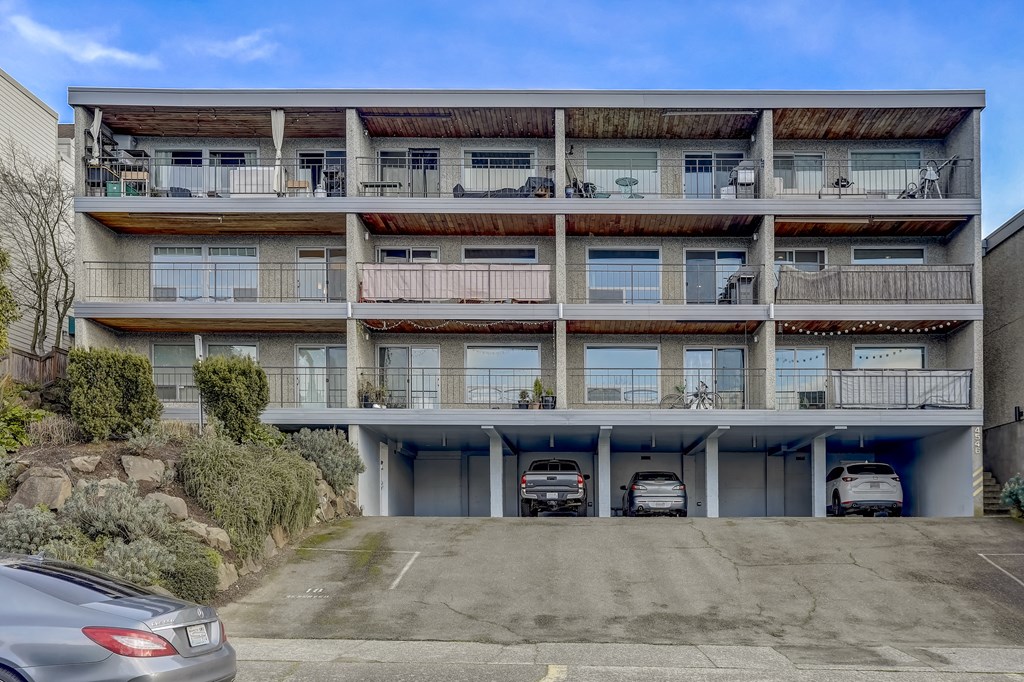 an empty parking lot in front of an apartment building