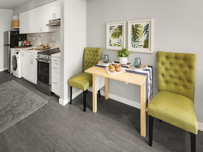 a kitchen and dining room with a table and chairs