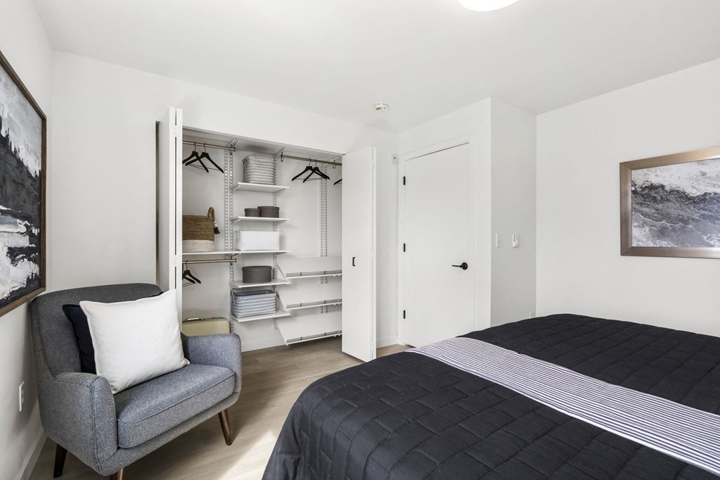 a bedroom with a bed and a chair