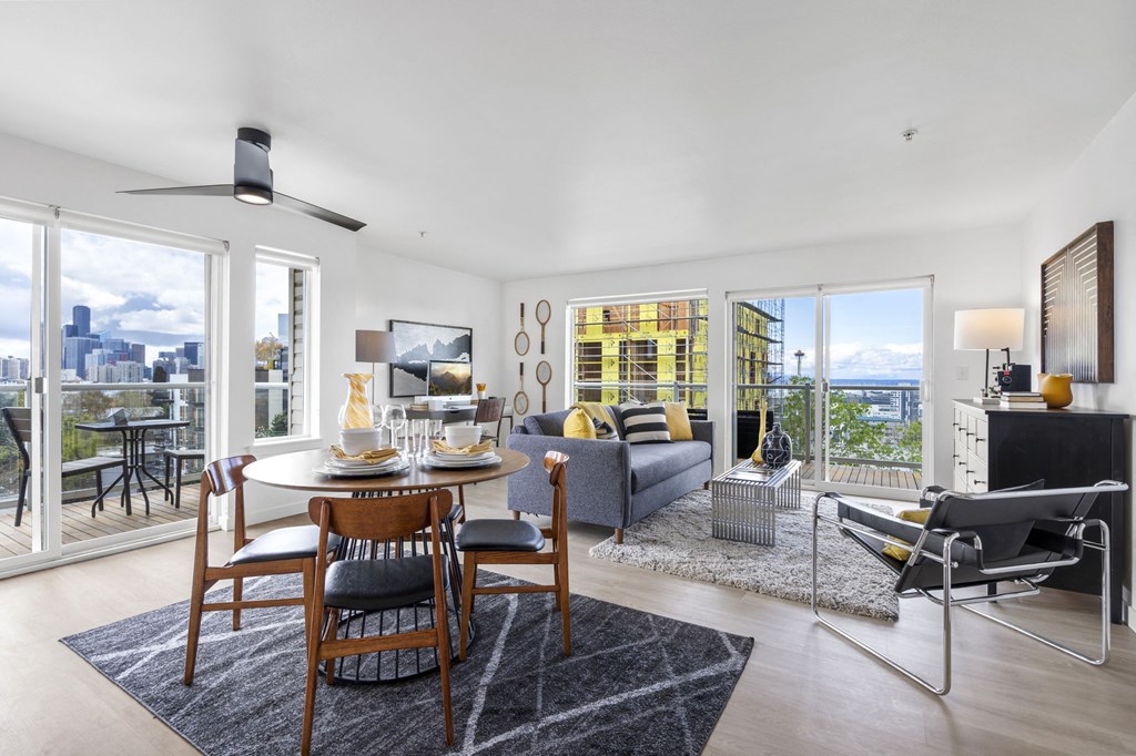 an open concept living room and dining room with a table and chairs and a couch and a