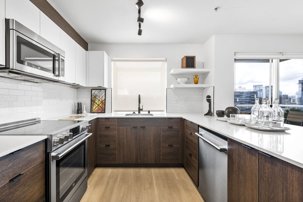 a kitchen with white countertops and wooden cabinetry