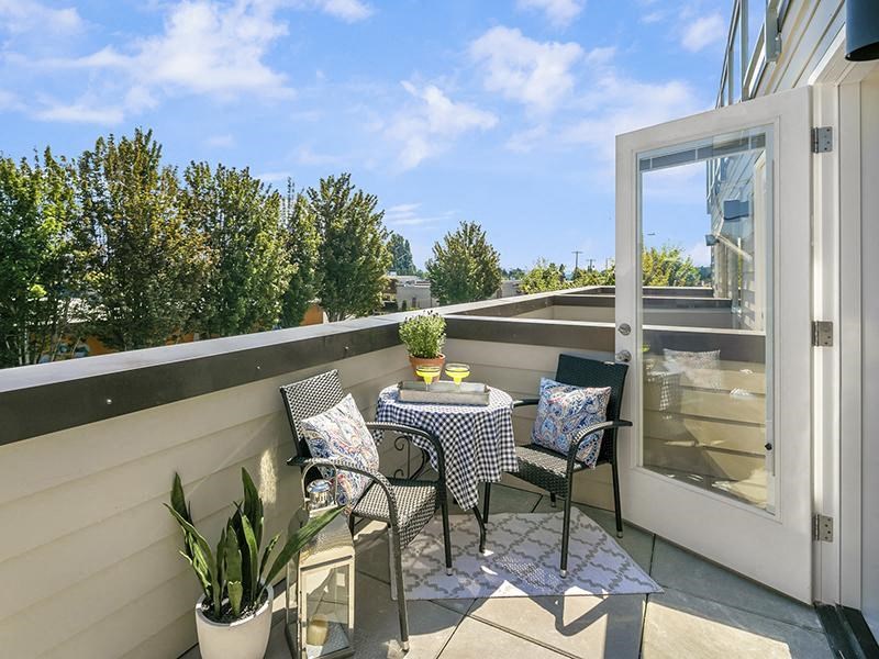 a patio with a table and chairs on a balcony