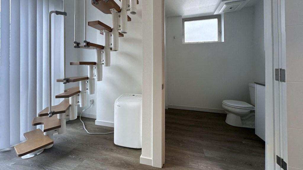 a small bathroom with a staircase and a toilet in it