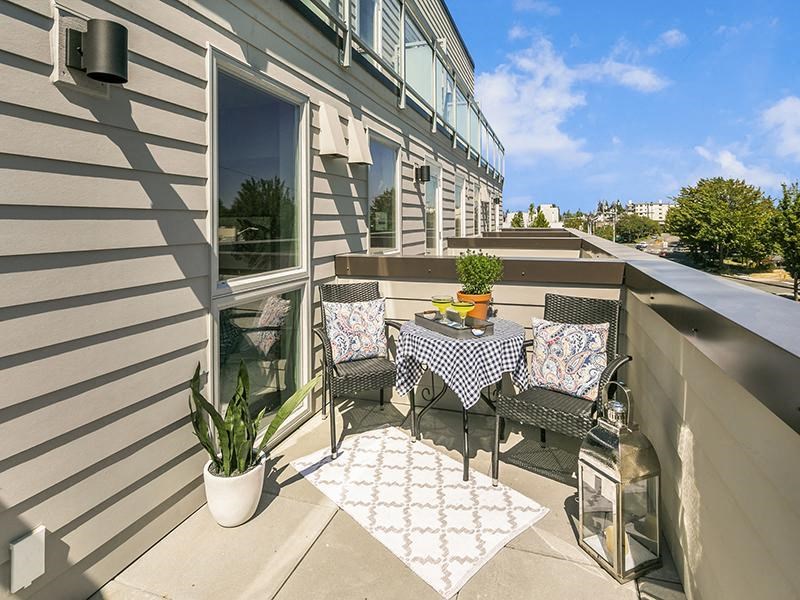 a patio with a table and chairs on a balcony