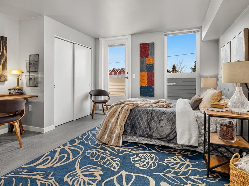 a bedroom with a bed and a blue rug