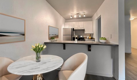a kitchen and dining room with a table and chairs