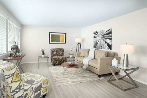 a living room with a couch chair and coffee table