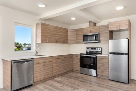 A modern kitchen with wooden cabinets and stainless steel appliances.