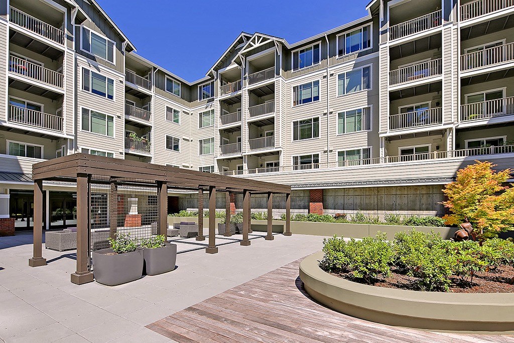 an outlook of an apartment building with a wooden walkway