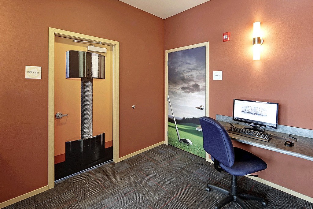 a room with a desk and a computer in it