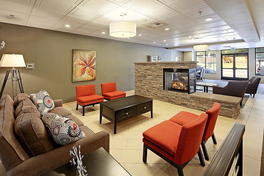 a living room with couches and chairs and a fireplace