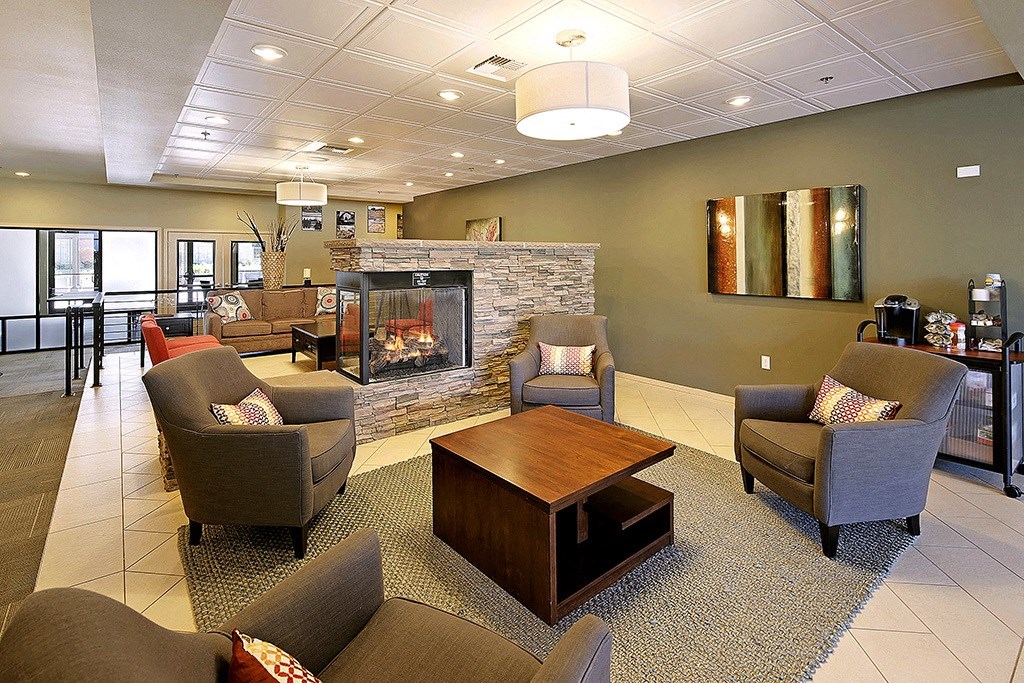 a living room with couches and chairs and a fireplace