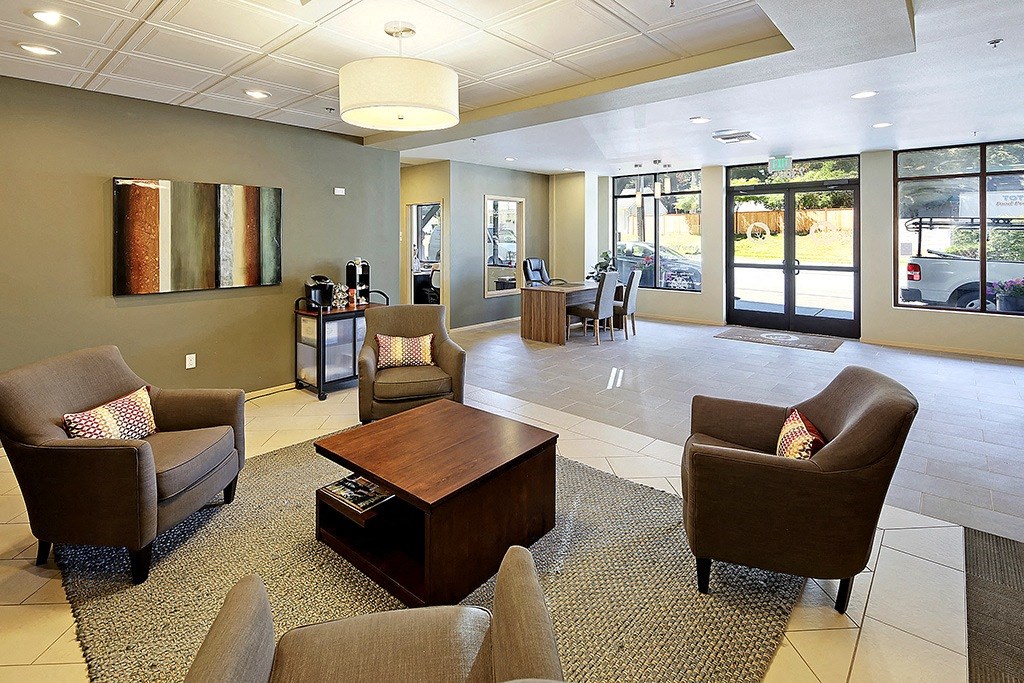 a living room with chairs and a coffee table
