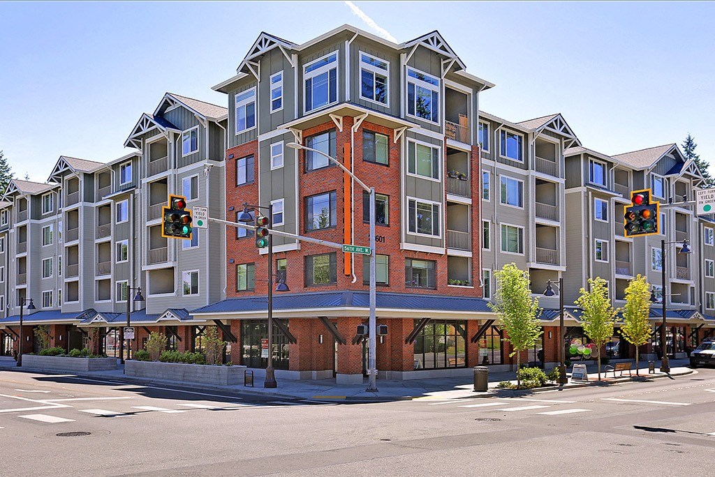 a large apartment building on the corner of a city street
