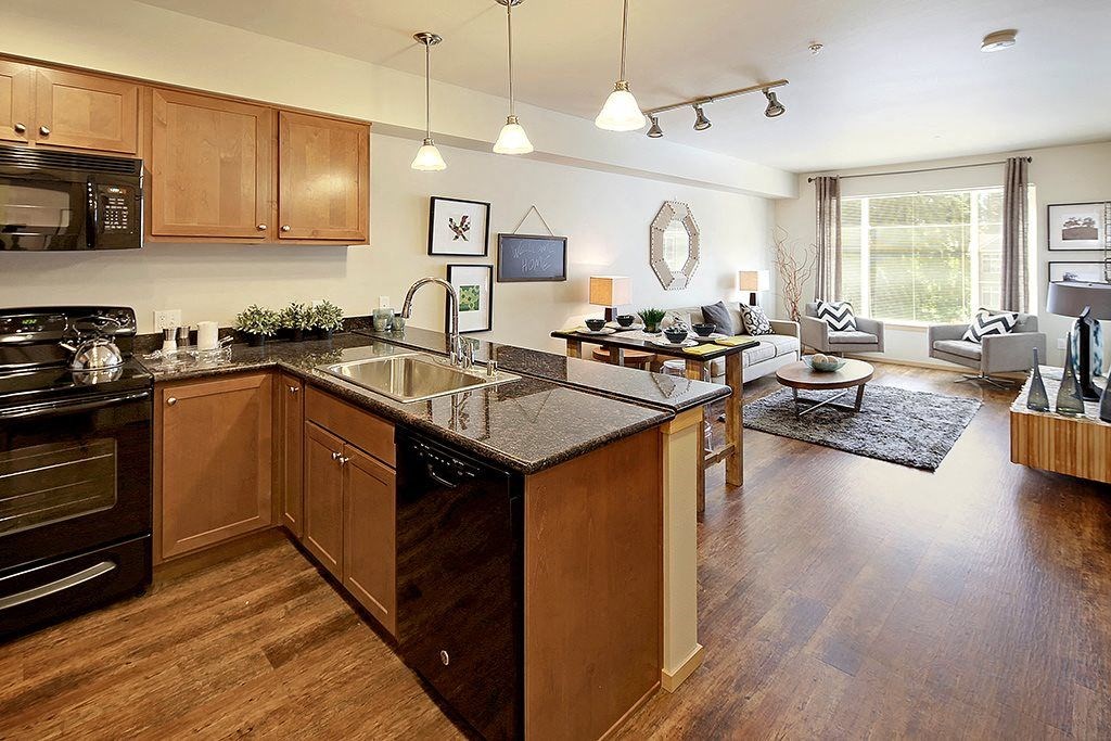 a kitchen with an island and a living room