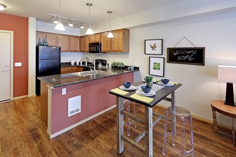 a kitchen with a bar and a counter top