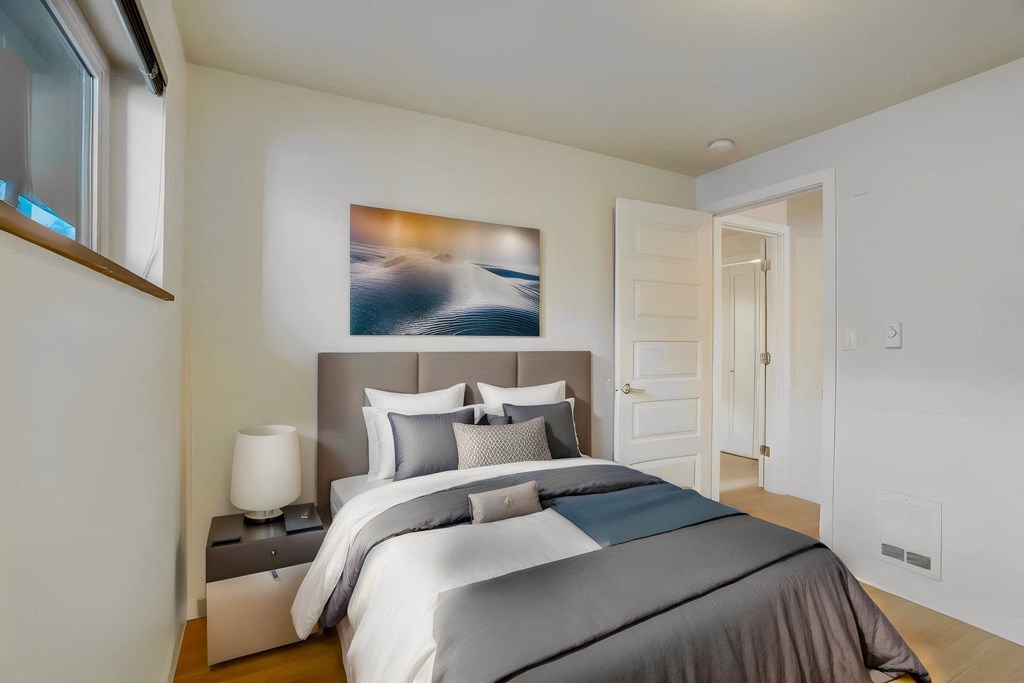 a bedroom with a bed and a door to a closet