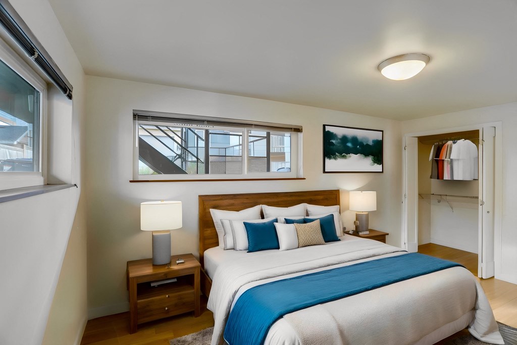 a bedroom with a bed and a window