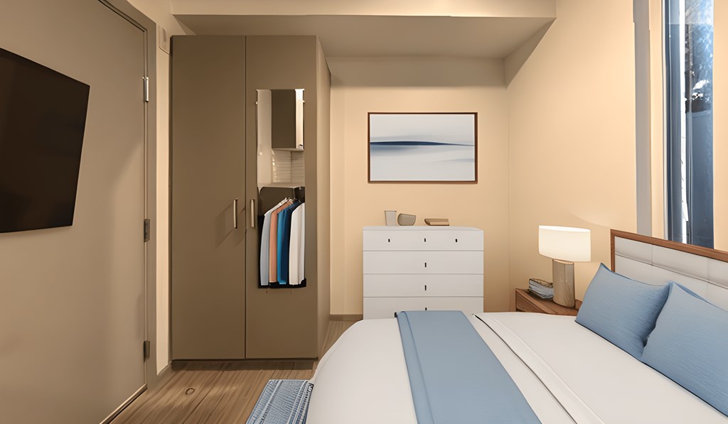 a bedroom with a bed and a dresser and a window