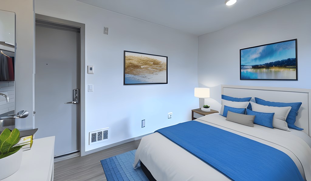 a bedroom with a bed and a door to a bathroom