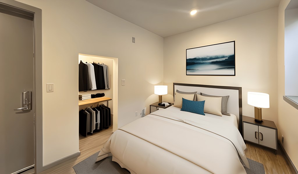 a bedroom with a large white bed and a closet