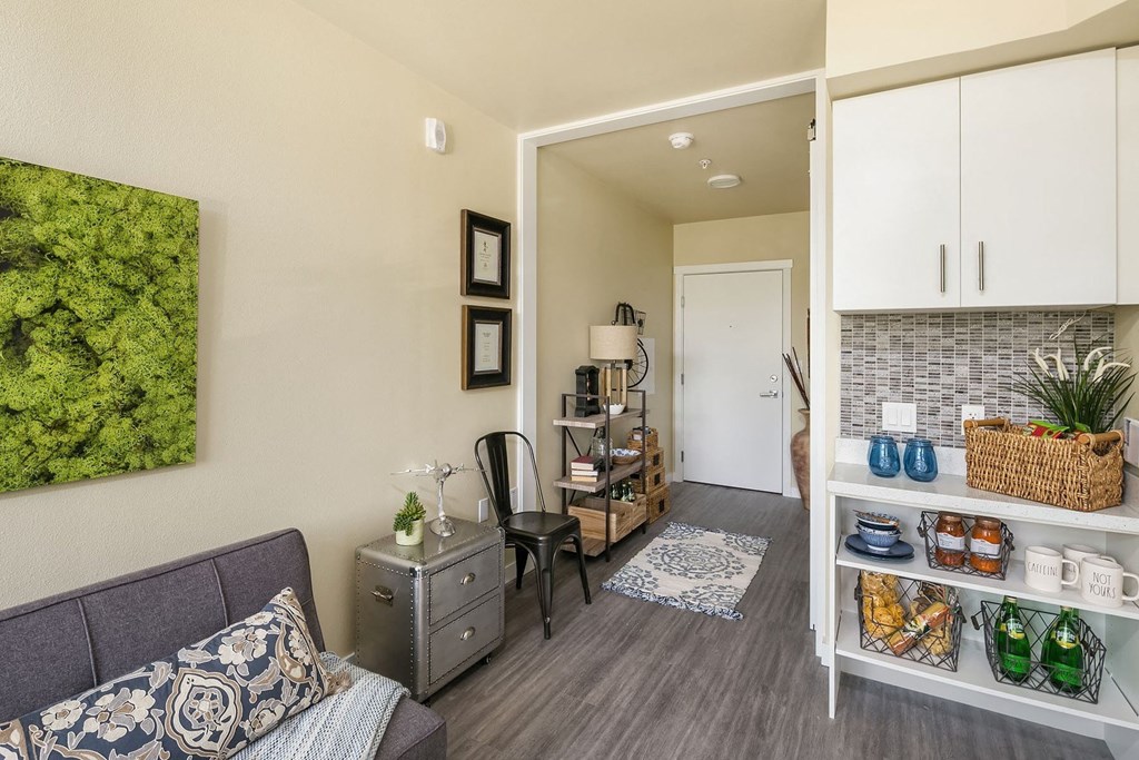 a living room with a couch and a door to a kitchen