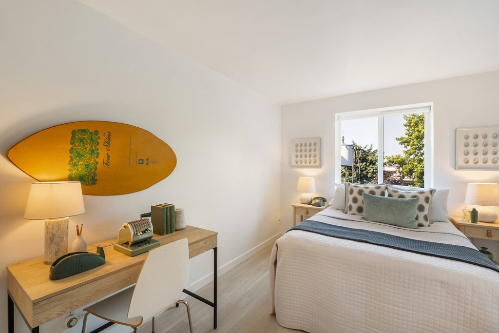 a bedroom with a surfboard on the wall
