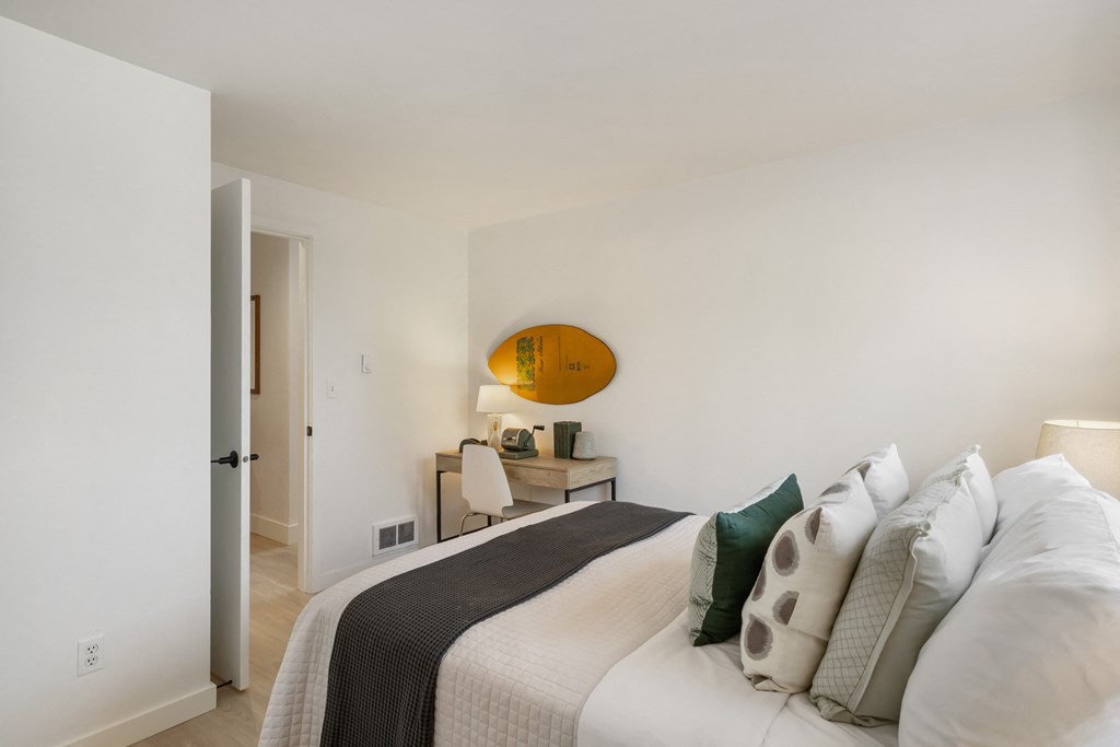 a bedroom with a bed and desk in a 555 waverly unit