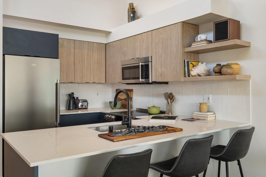 a kitchen with wooden cabinets and a white counter top