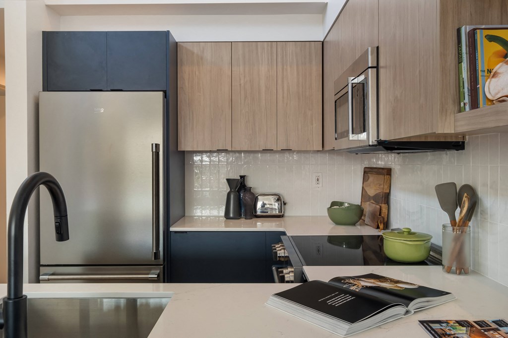 a kitchen with wooden cabinets and stainless steel appliances