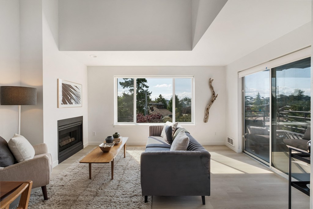 a living room with a couch and a coffee table in front of a fireplace