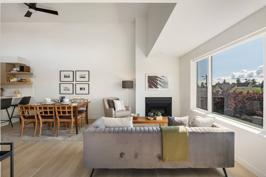 a view of the living room and dining area of a house with a large window
