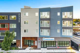 a photo of the front of a building with a blue sky in the background
